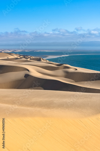 Namibia, the Namib desert, graphic landscape of yellow dunes falling into the sea
