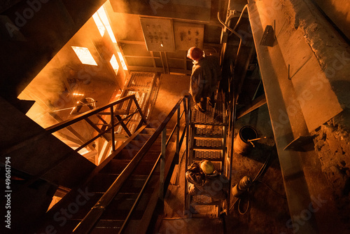 Steelworkers at work near the working arc furnace