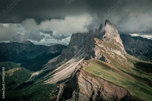 Billede på lærred Dramatic mountain peaks of Seceda with clouds in the European Dolomite Alps, meadow in the foreground, steep cliff, South Tyrol Italy