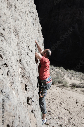 side view of man climbing on rock