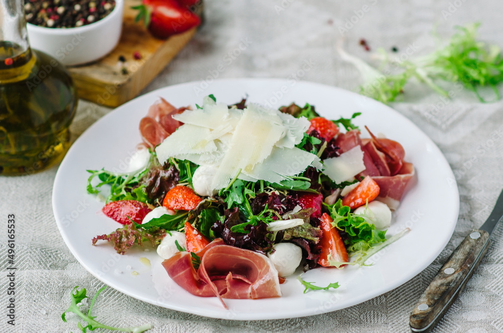Salad mix with jamon, baby mozzarella, strawberries and vinaigrette sauce. Salad mix with jamon, baby mozzarella, strawberries and vinaigrette sauce.