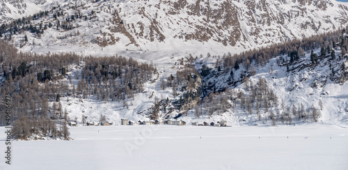 Stampa village on frozen mountain lake, from Plaun da Lej, Switzerland photo