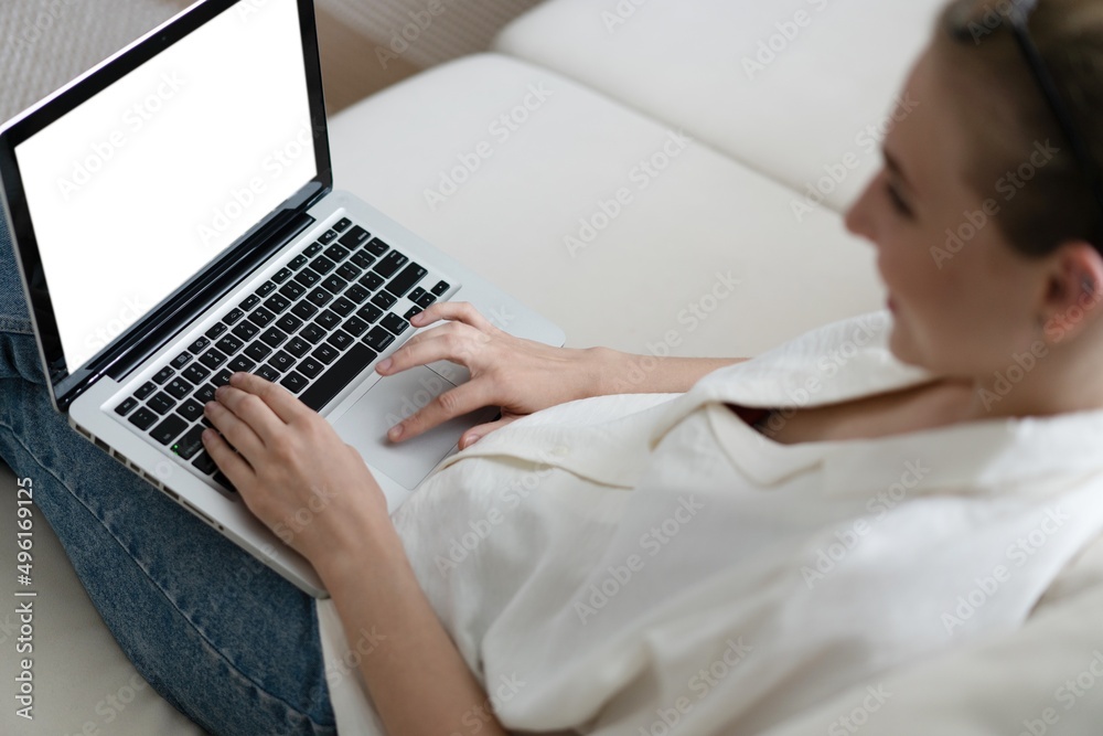 Mockup image of a woman using and typing on laptop computer keyboard with blank white desktop screen. Mockup image of a woman using and typing on laptop computer keyboard with blank white desktop screen.