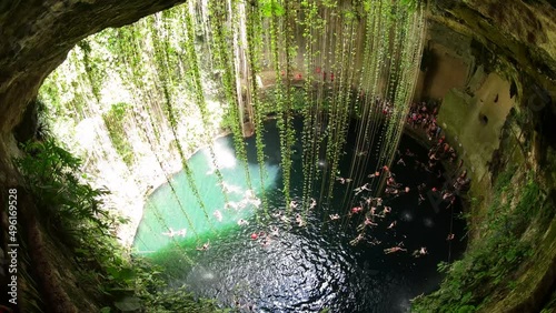 Cenotes are underground natural pools and sacred Mayan ceremonial spaces. Today these cave-like swimming pools provide the most perfect way to cool off and escape the heat of the sun in Yucatan, Mexic photo