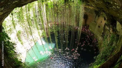 Cenotes are underground natural pools and sacred Mayan ceremonial spaces. Today these cave-like swimming pools provide the most perfect way to cool off and escape the heat of the sun in Yucatan, Mexic photo