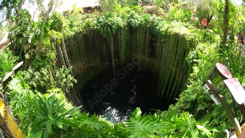 Cenotes are underground natural pools and sacred Mayan ceremonial spaces. Today these cave-like swimming pools provide the most perfect way to cool off and escape the heat of the sun in Yucatan, Mexic photo