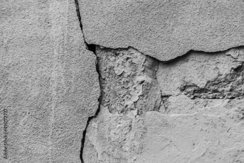 Old crack broken gray concrete wall damage background grey cracked texture