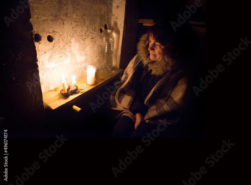 Frightened woman hide from explosions in the basement. During the sirens due to the shelling of Kyiv. Ukraine. 26 February 2022 © Marina