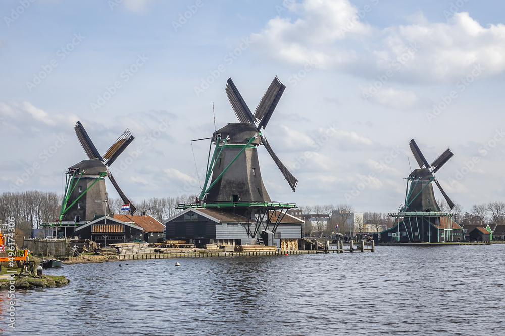 View of Zaanse Schans - museum village in Zaandam with Dutch houses and windmills. ZAANDAM, The NETHERLANDS. MARCH 12, 2022.
