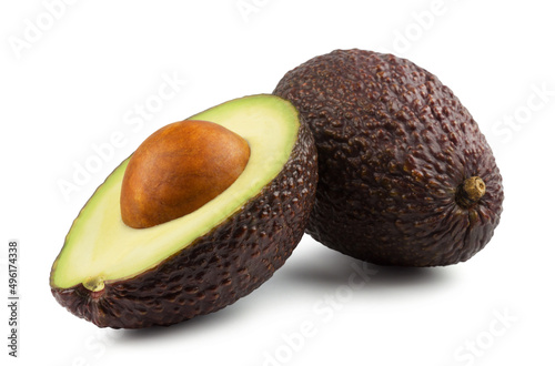 Ripe dark avocado and avocado half isolated on white background.