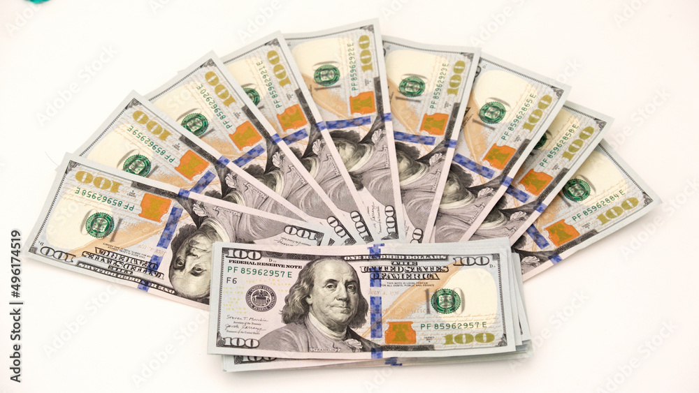 A sheet of new hundred dollar bills are laid out on the table, in a row and in a circle. Great background for filling. A sheet of new hundred dollar bills are laid out on the table, in a row and in a circle. Great background for filling.