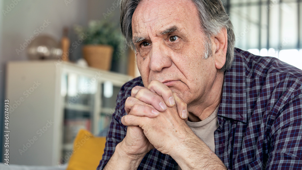 Thoughtful elderly man sitting alone at home Thoughtful elderly man sitting alone at home