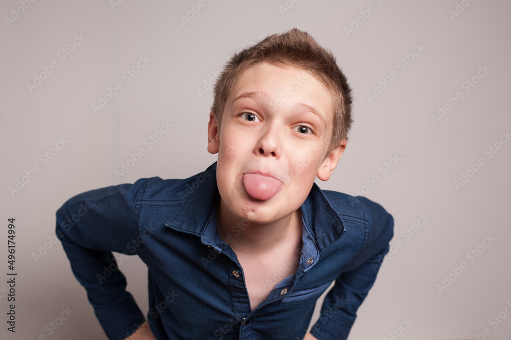 A playful boy showing his tongue on a camera A playful boy showing his tongue on a camera