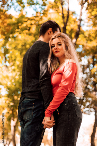  Loving couple embracing stands in the autumn park © Ирина Санжаровская