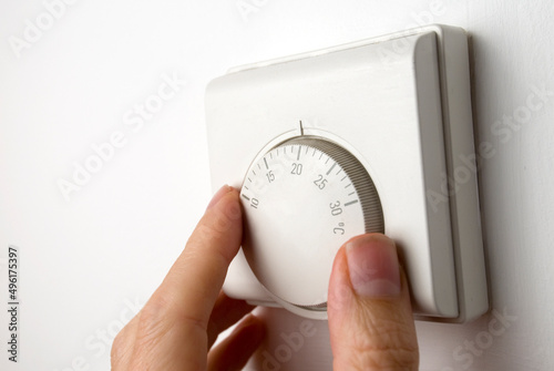 Fotografie room wall thermostat being adjusted