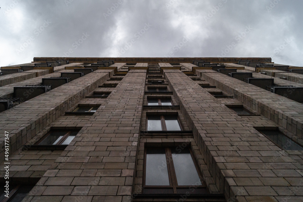 The multi-story building was built in the Soviet Union. The building was built in the constructivist style. The wall of a multi-storey building with windows. Hotel Ukraine in Kyiv The multi-story building was built in the Soviet Union. The building was built in the constructivist style. The wall of a multi-storey building with windows. Hotel Ukraine in Kyiv