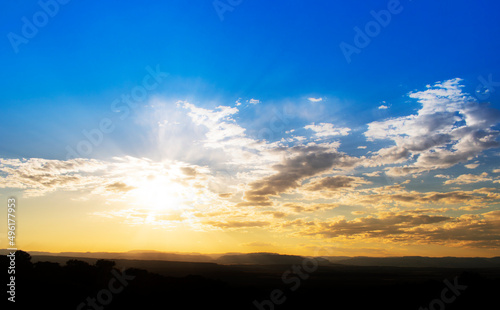 Beautiful sunset with blue and orange colors and sun rays © Isaac