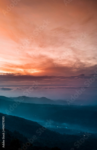Fototapeta Naklejka Na Ścianę i Meble -  Mountains under mist in the morning Amazing nature scenery  form Munnar Kerala God's own Country Tourism and travel concept image, Fresh and relax type nature image