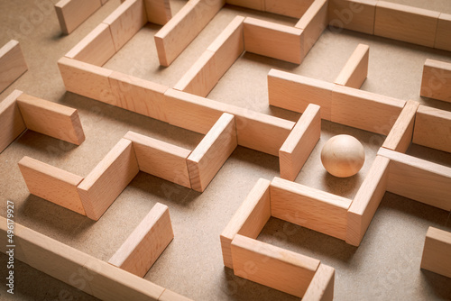 Photography Wooden blocks maze game with wooden ball as subject to find the exit, complicate