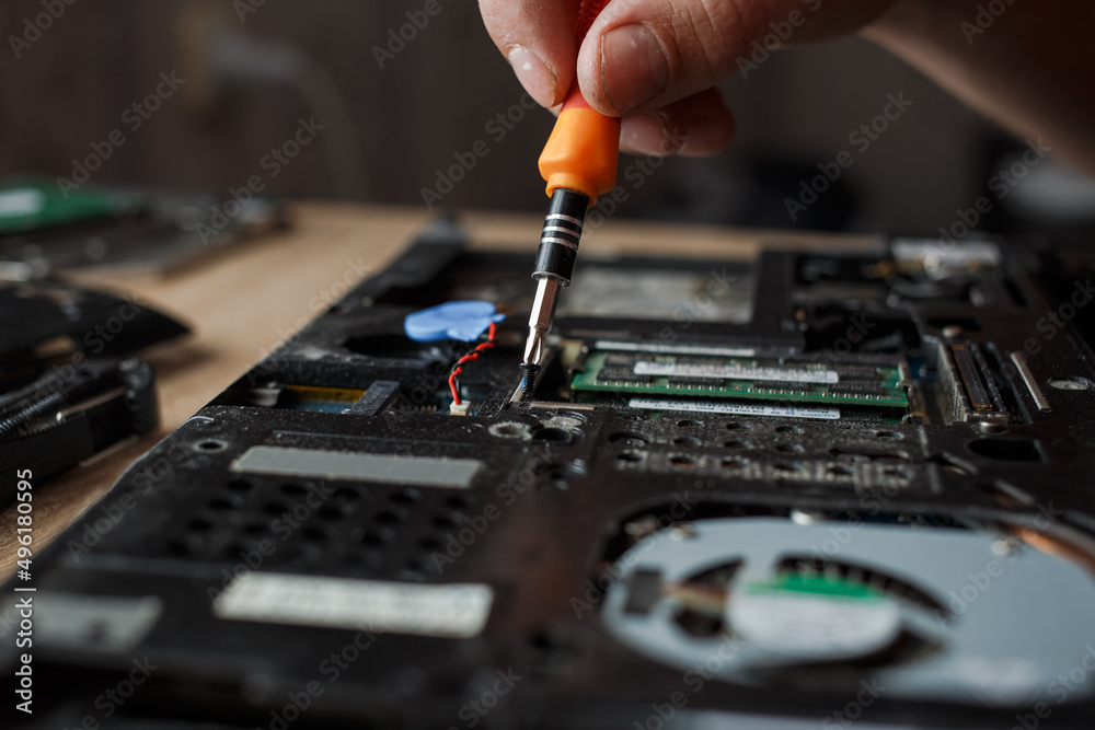 Man repairs laptop by himself, computer repair Man repairs laptop by himself, computer repair