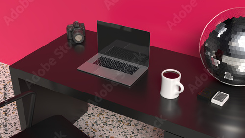 Home office desk with magenta wall and black table with laptop and disco ball