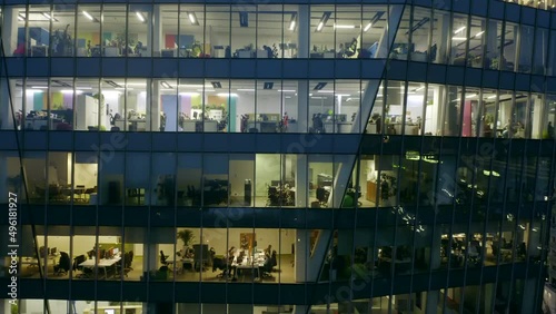 Aerial view of the windows of the skyscraper and office space at night. 