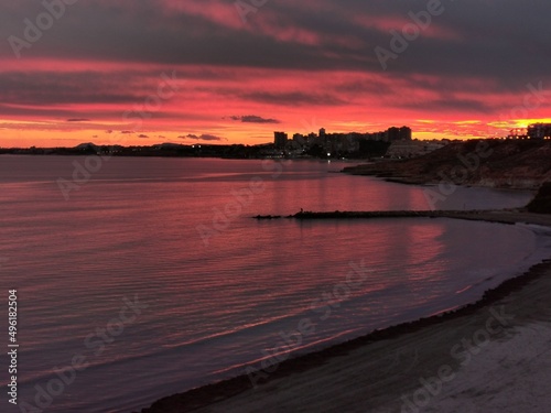 Cloudy rose blue sunset over dark silhouettes of city buildings, Evening view. High quality photo