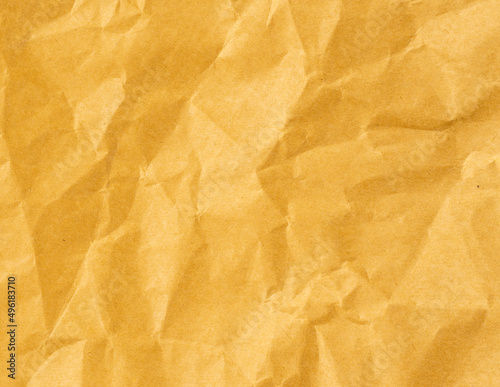 Wrinkled sheet of yellow paper. Textured backdrop