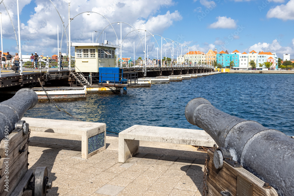 Cannon pointing at the famous queen emma bridge and buildings of Otrobanda in Willemstad, Curacao