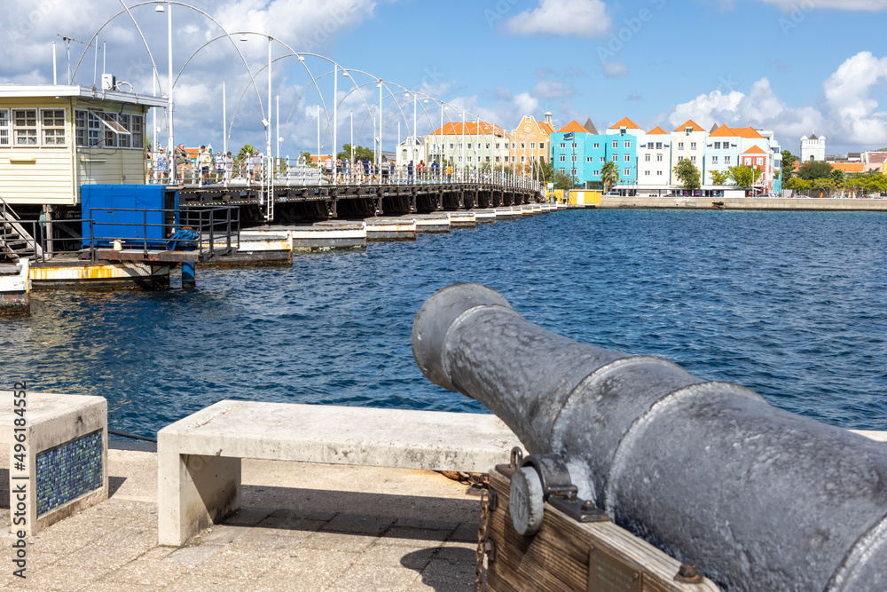 Cannon pointing at the famous queen emma bridge and buildings of Otrobanda in Willemstad, Curacao