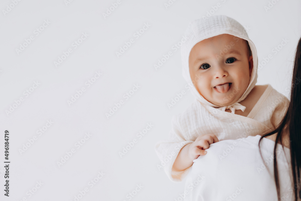 Loving mother carying of her newborn baby at home. Bright portrait of happy mum holding cute infant child on hands. Mother hugging her little 3 months old daughter. Loving mother carying of her newborn baby at home. Bright portrait of happy mum holding cute infant child on hands. Mother hugging her little 3 months old daughter.