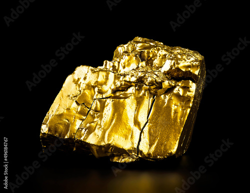 Gold nugget on black background. Close up the gold ore.