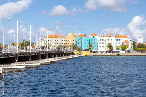 The famous Queen-Emma-Bridge with colorful buildings of the district Otrobanda in Willemstad, Curacao