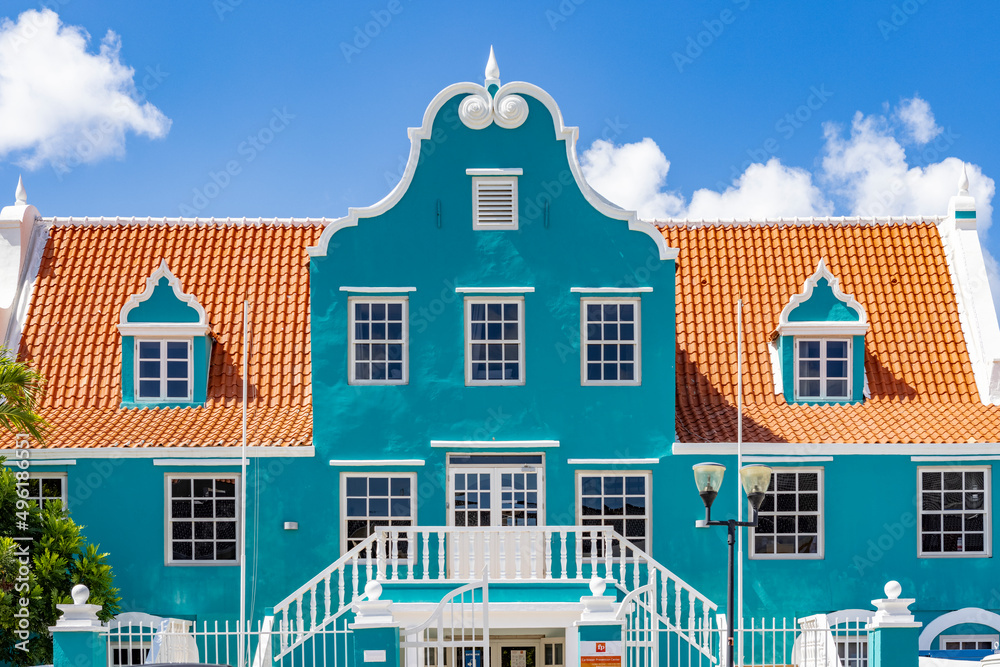Beautiful building with a turquoise facade, white details and an orange roof in Willemstad, Curacao