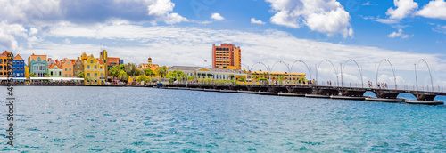 Famous colorful waterfront buildings in dutch-caribbean, colonial style and Queen-Emma-Bridge viewed from the district Otrobanda in Willemstad, Curacao