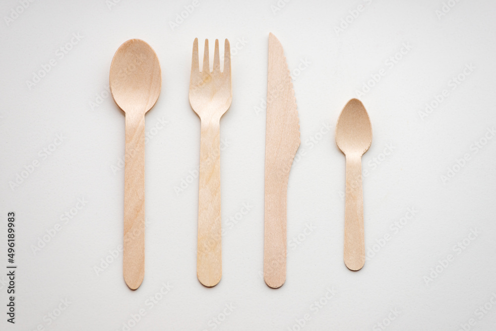 Wooden eco-friendly cutlery lies in a row, isolated Wooden eco-friendly cutlery lies in a row, isolated