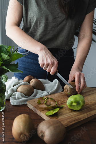 Fresh and ripe kiwi sliced ​​on a wooden kitchen board