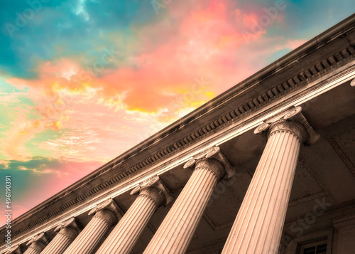 Classical columns on government building with colorful sky