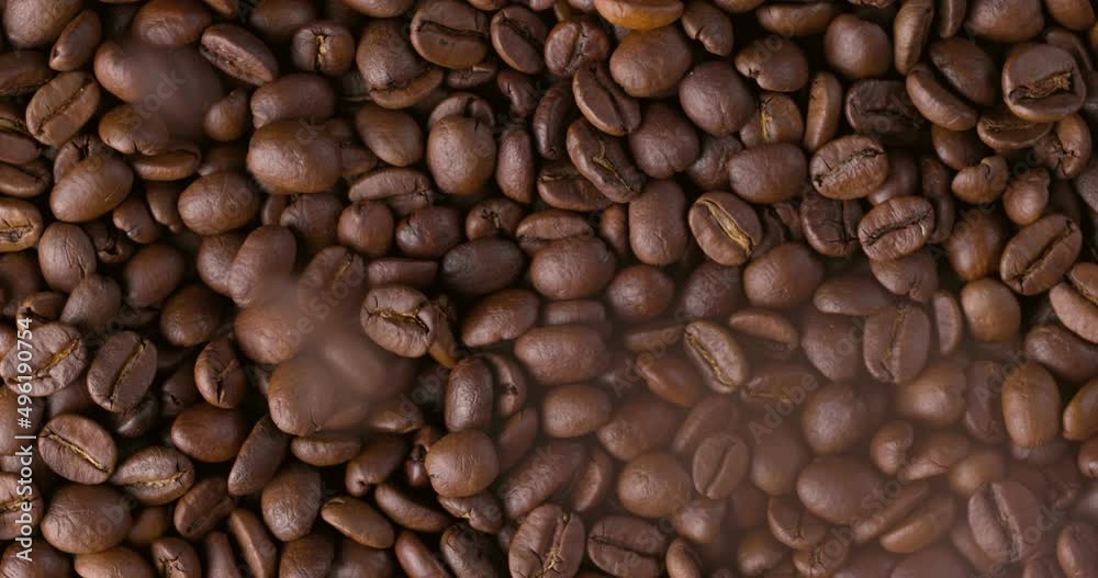 Slow motion close-up of whole roasted coffee beans. Rotation and fall сoffee beans Slow motion close-up of whole roasted coffee beans. Rotation and fall сoffee beans