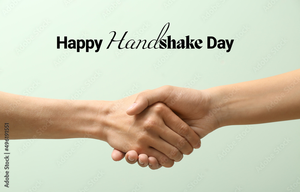 Women shaking hands on light color background. Happy Handshake Day Women shaking hands on light color background. Happy Handshake Day