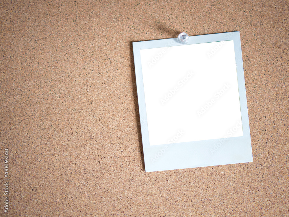 Blank white photo card template on cork board background for photo