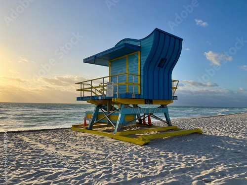 Iconic blue and yellow lifeguard house in Miami Beach. Beautiful sky at sunrise © Pedro
