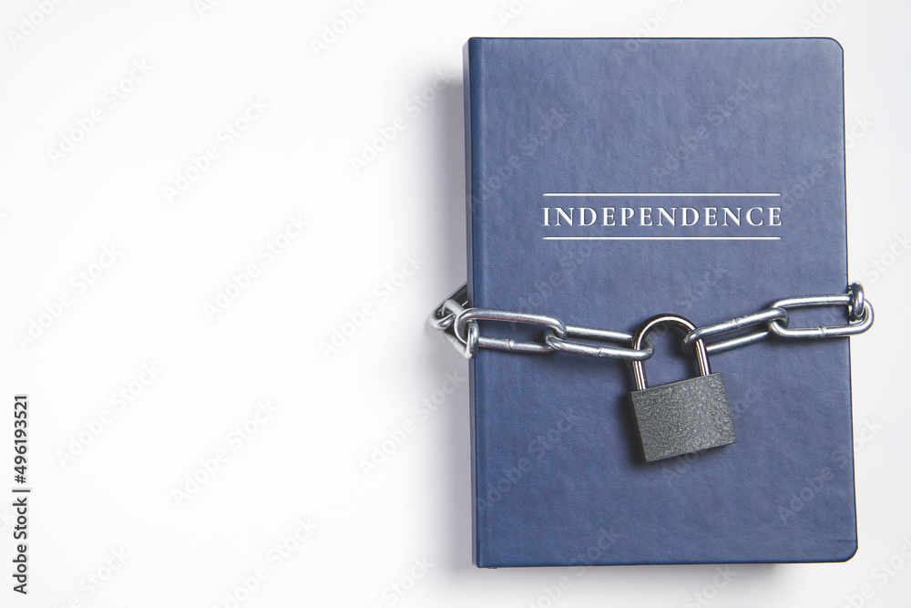 Independence. The book was wrapped in a chain. On a white background. Independence. The book was wrapped in a chain. On a white background.