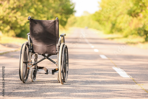 Empty modern wheelchair on road outdoors © Pixel-Shot
