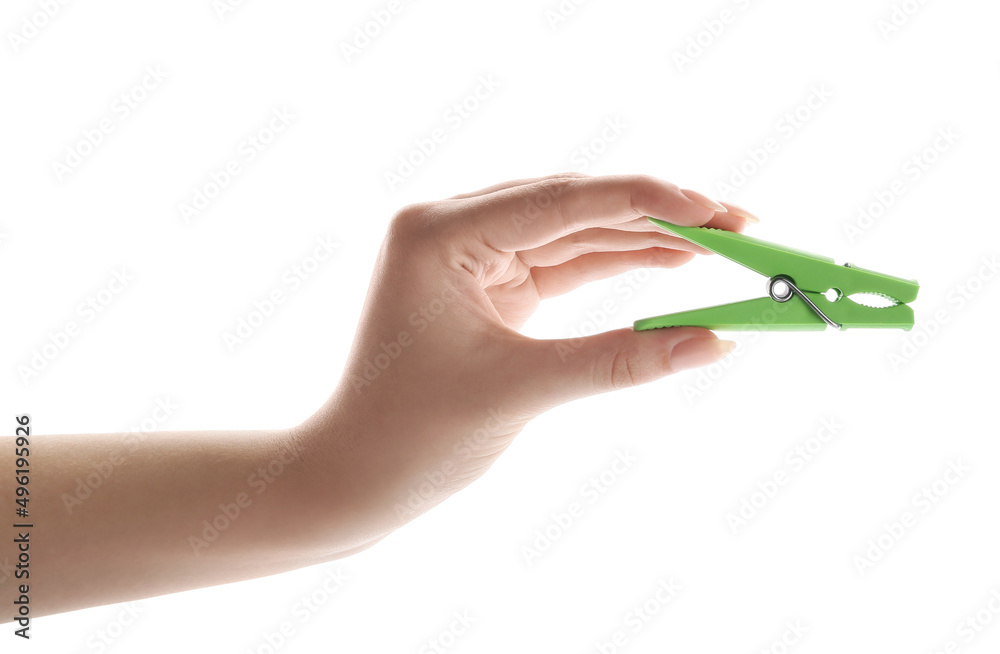 Female hand with plastic clothes pin on white background Female hand with plastic clothes pin on white background