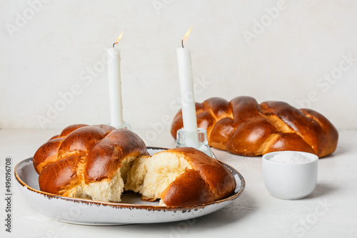 Canvastavla Traditional challah bread with glowing candles on white background