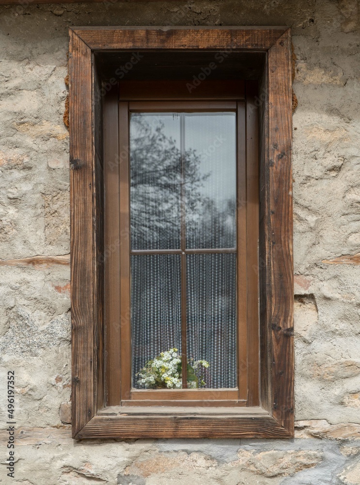 Old wooden window with a flower