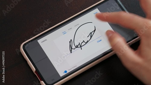 Electonic signature with finger in phone screen photo