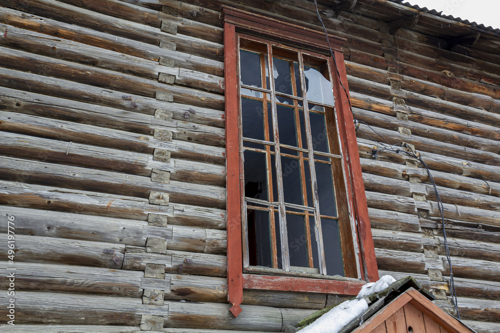 Fototapeta premium Facade window of a house with broken glass. Destroyed by an explosion residential apartment building.