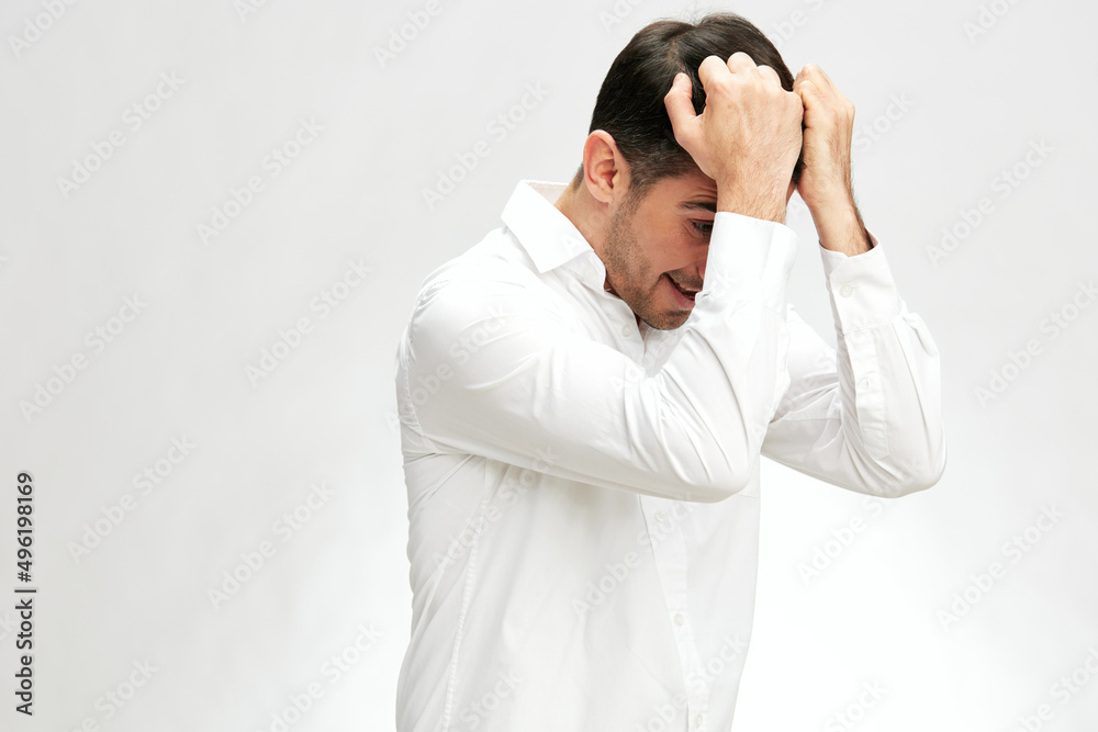 handsome man holding his head in white shirts hand gesture copy-space elegant style handsome man holding his head in white shirts hand gesture copy-space elegant style